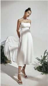 Silk midi dress with ruched bodice and adjustable side ties for elegant feminine silhouette